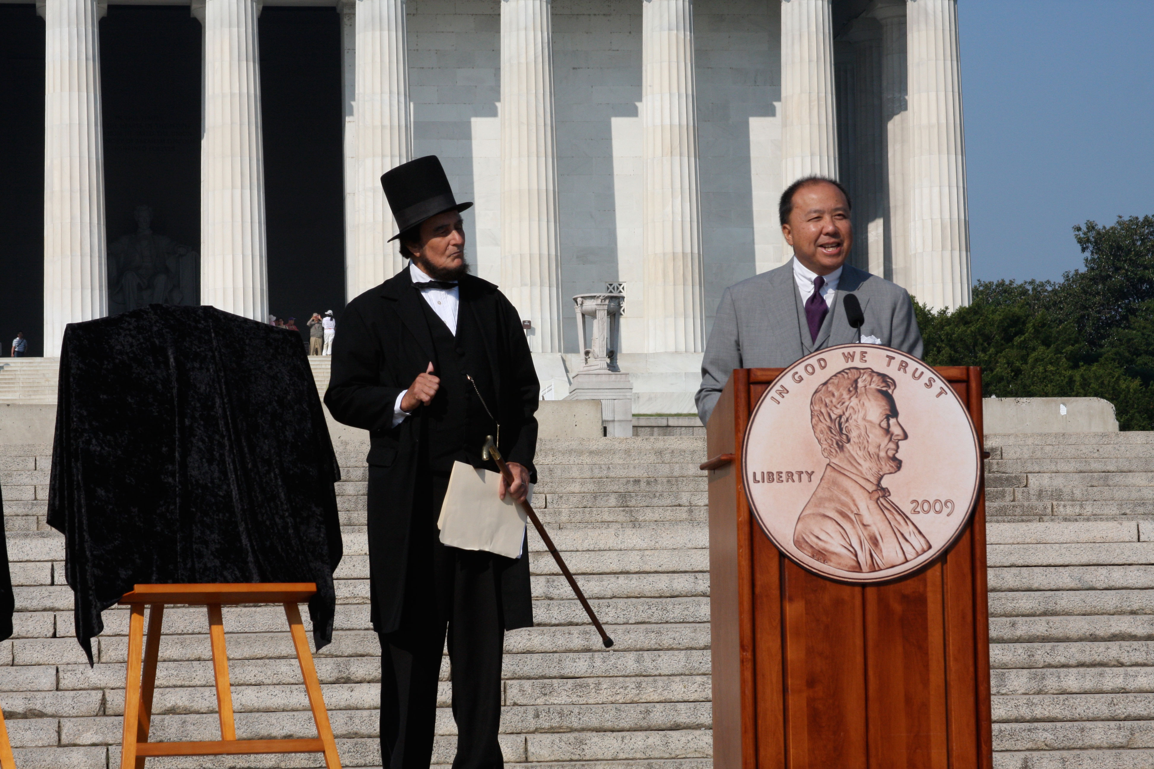 With President Abraham Lincoln, I am delivering remarks before unveiling the four new penny designs to celebrate the Lincoln bicentennial in 2009.